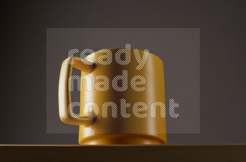 Low angle shot of a yellow cup on grey background