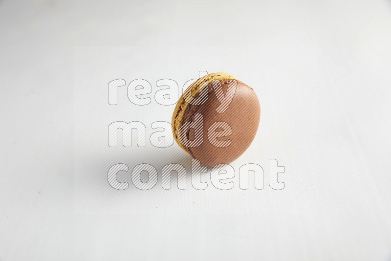 45º Shot of Yellow and Brown Chai Latte macaron on white background