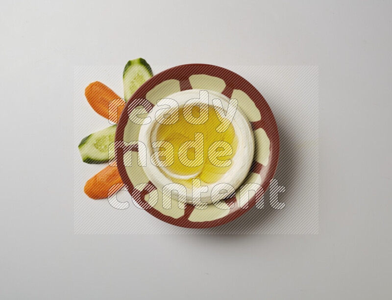Lebnah garnished with olive oil in a traditional plate on a white background