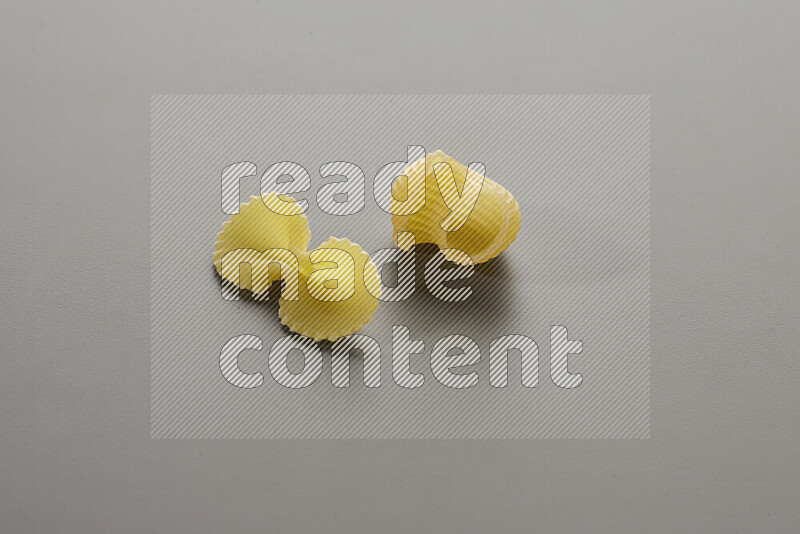 Fiocchi pasta with other types of pasta on grey background