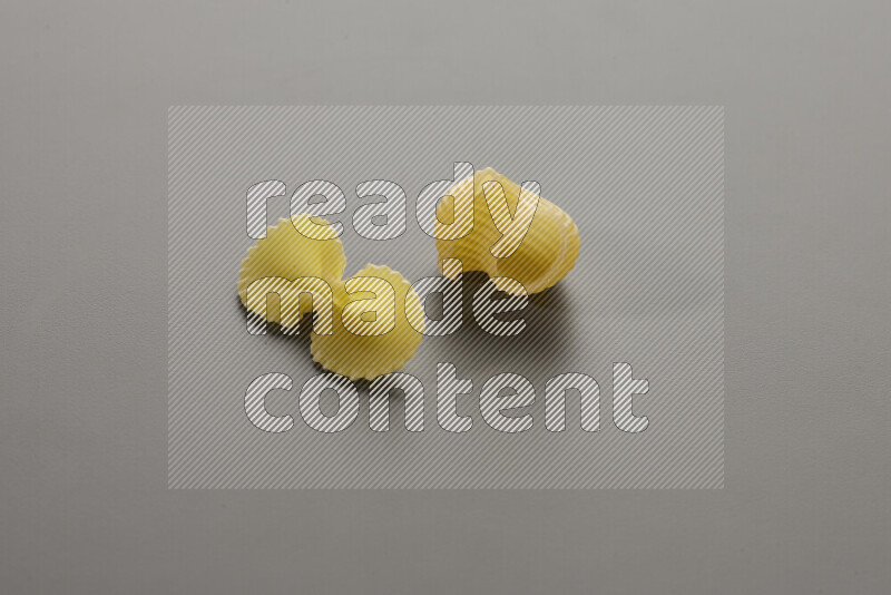 Fiocchi pasta with other types of pasta on grey background