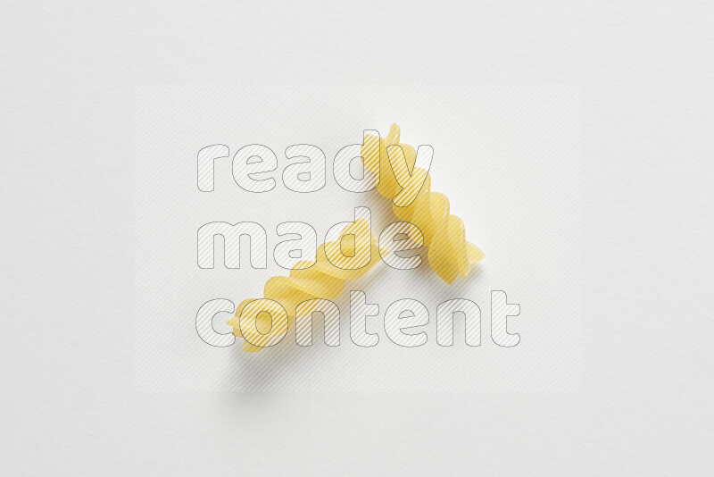 Fusilli pasta on white background