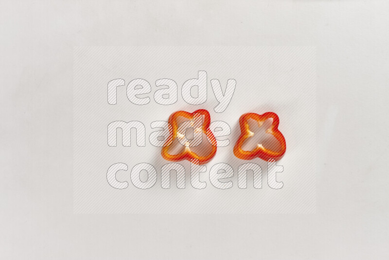 Red bell pepper slices on white background