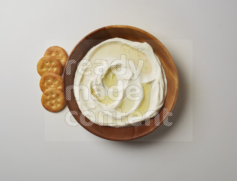 Lebnah garnished with olive oil in a wooden plate on a white background