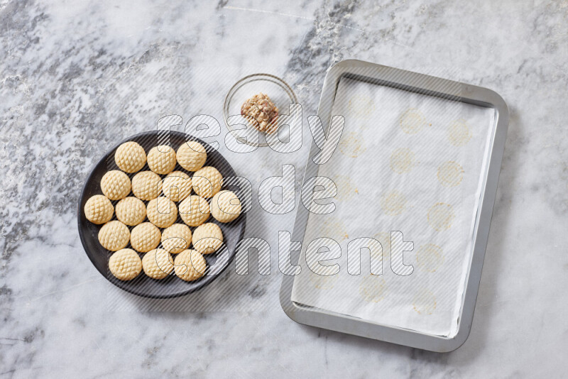 Kahk step by step with its ingredients ghee, sugar, flour, sesame, yeast, water and kahk flavor on grey marble background