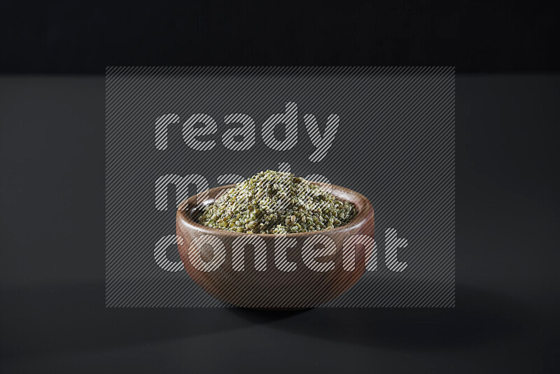 Freekeh in a wooden bowl on grey background