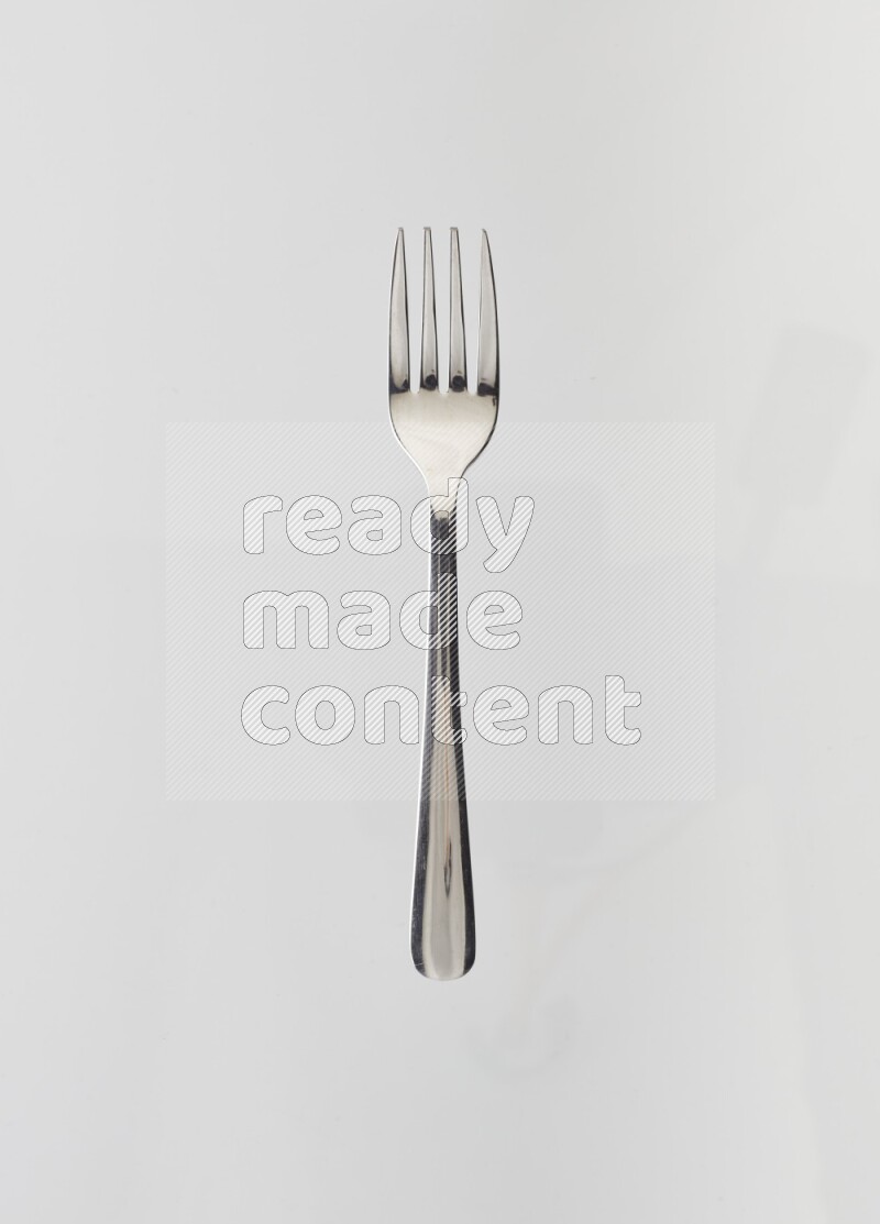 Silver stainless steel fork on white background