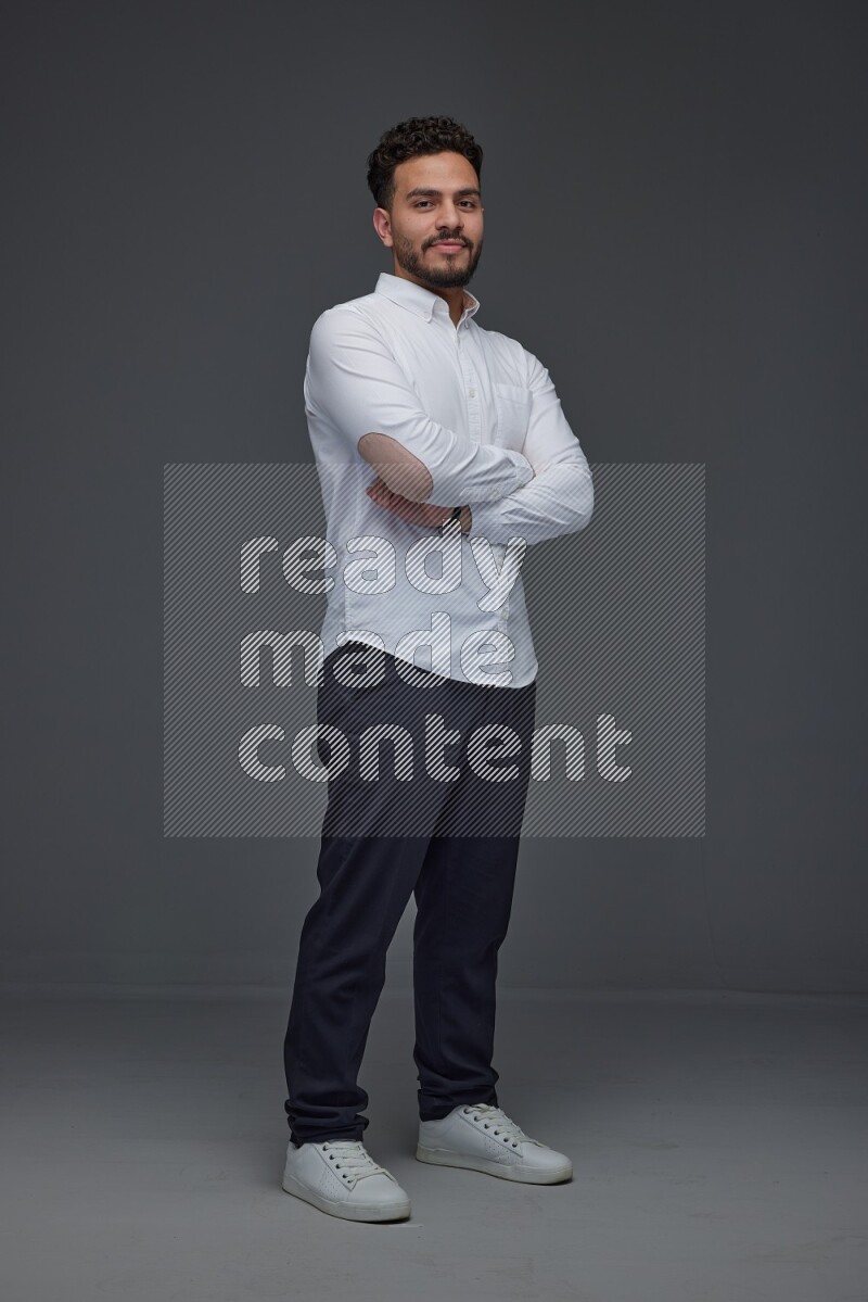 A man wearing smart casual making multi stand poses  eye level on a gray background