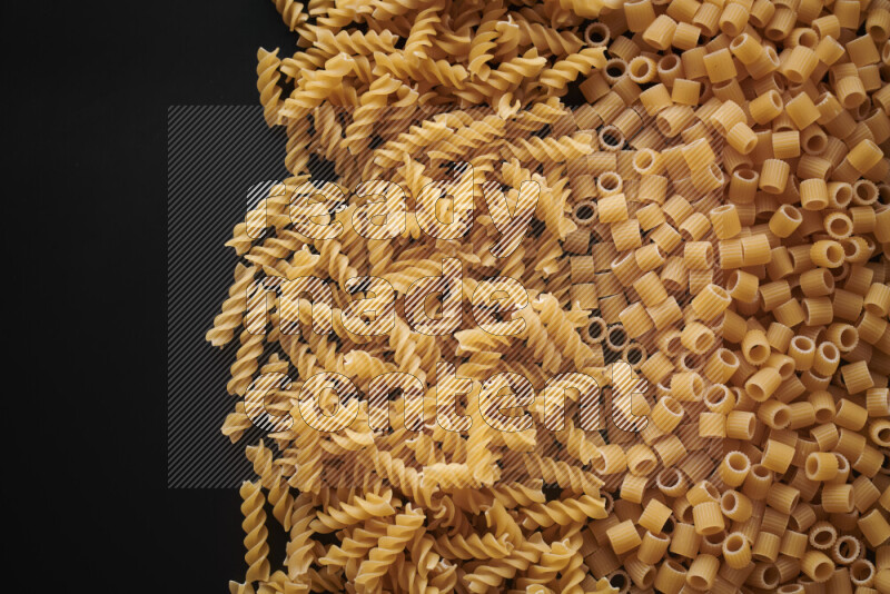 Different pasta types on black background