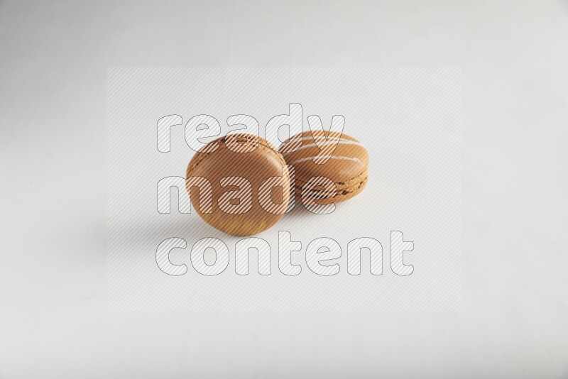 45º Shot of of two assorted Brown Irish Cream, and Brown Coffee macarons  on white background