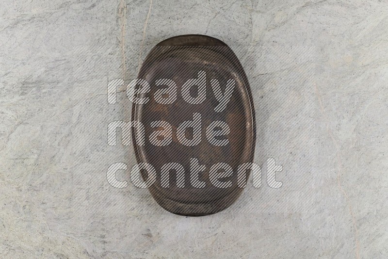 Top View Shot Of A Vintage Metal Tray On Grey Marble Flooring