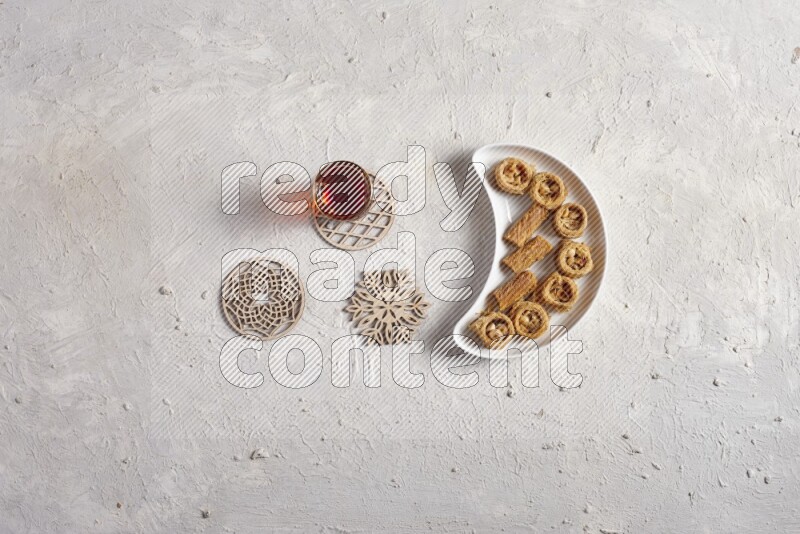 Oriental sweets in a pottery plate with drinks in a light setup