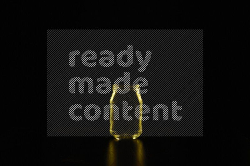 Glassware with rim light in yellow against black background