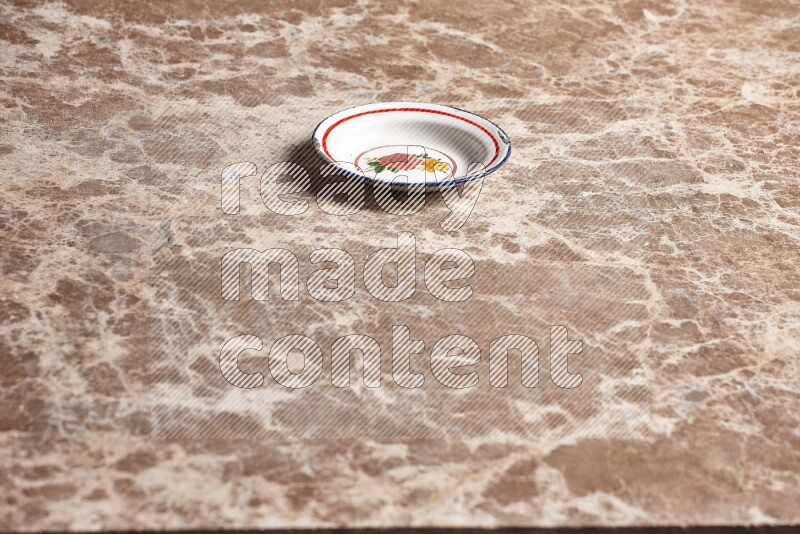 A vintage metal plate on beige marble background