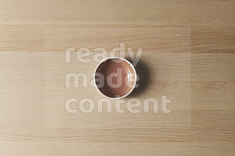 Top View Shot Of A Brown Pottery Bowl on Oak Wooden Flooring