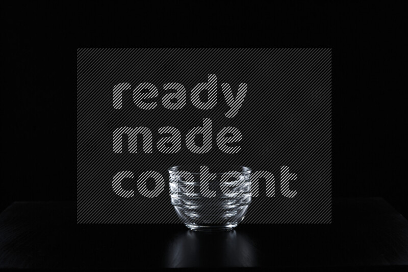 Glassware with rim light against black background