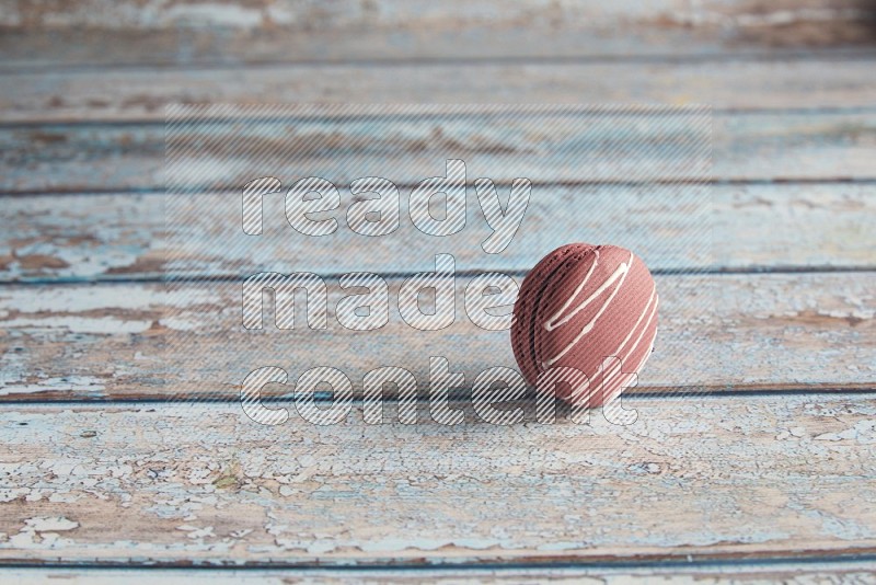 45º Shot of Red Poppy Flower macaron on light blue wooden background