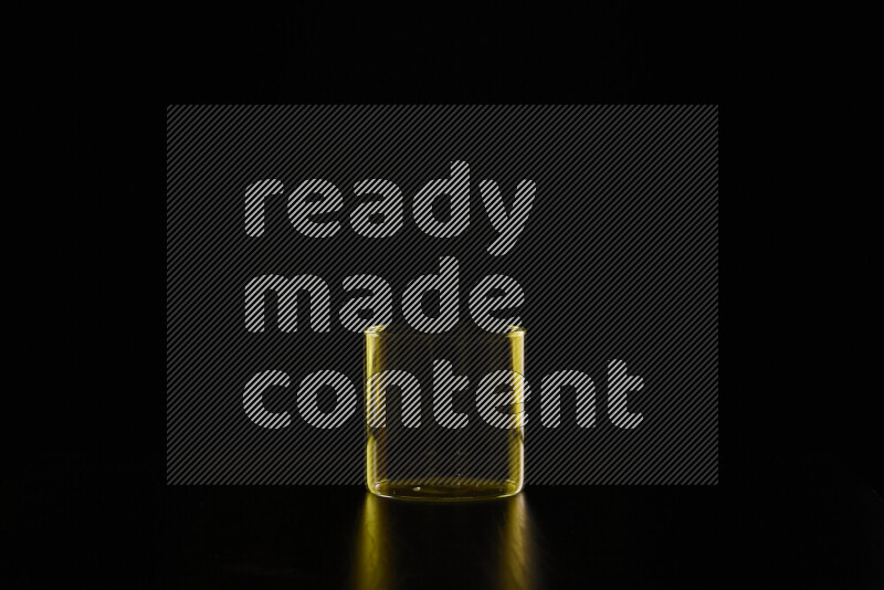 Glassware with rim light in yellow against black background