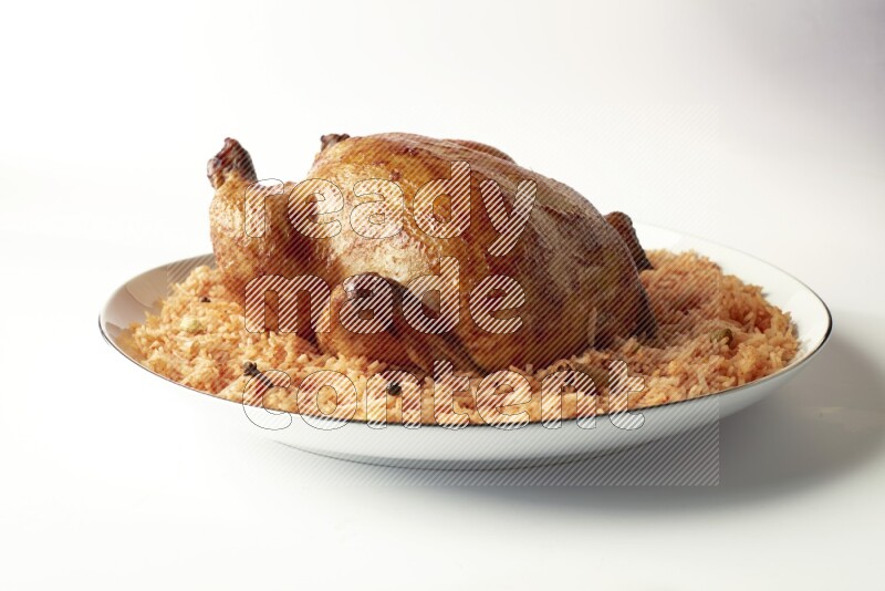 red basmati Rice with whole roasted chicken on a white plate with a silver rim direct on white background