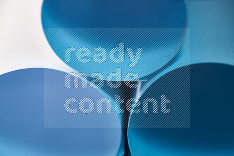 The image shows an abstract paper art with circular shapes in varying shades of blue