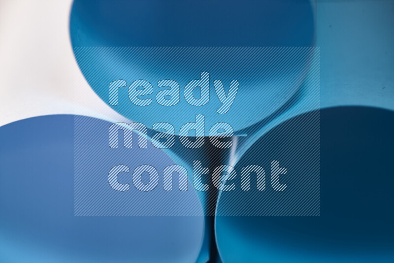 The image shows an abstract paper art with circular shapes in varying shades of blue