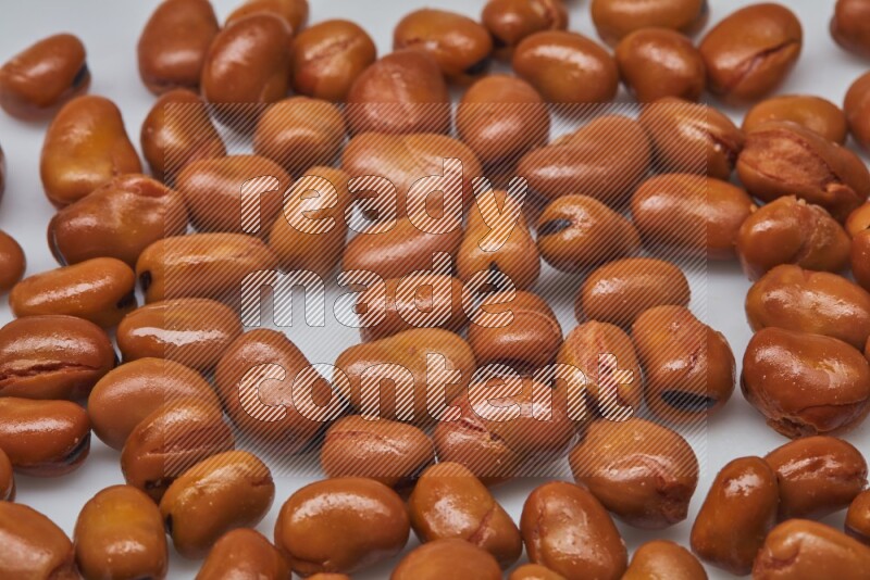 Close up shot of cooked fava beans (foul) on white background