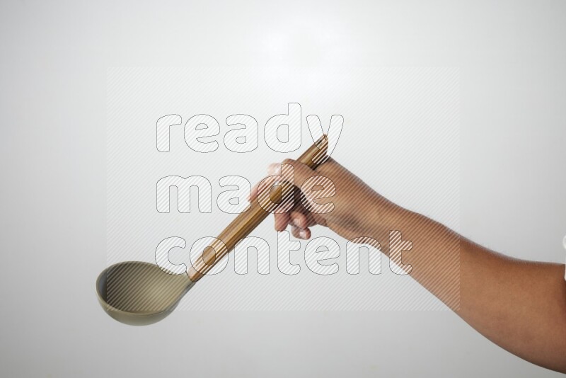 Male Hand Holding ladle on white background