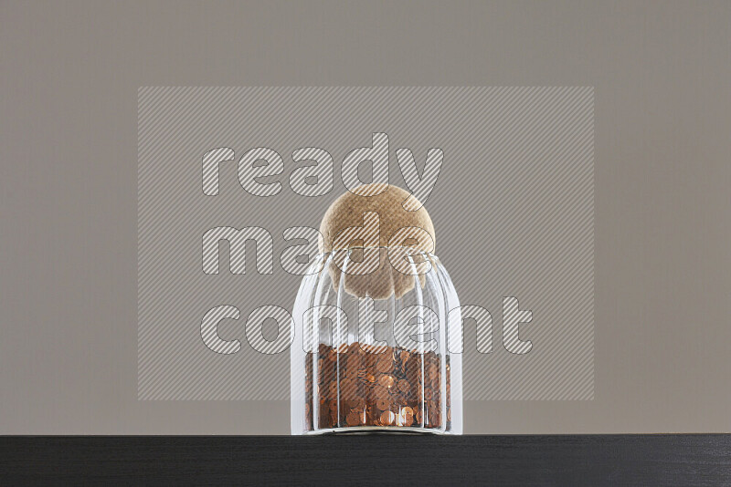 Sequins in a glass jar on black background