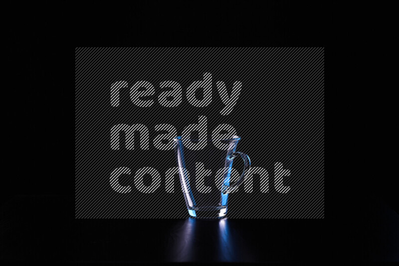 Glassware with rim light in blue and white against black background