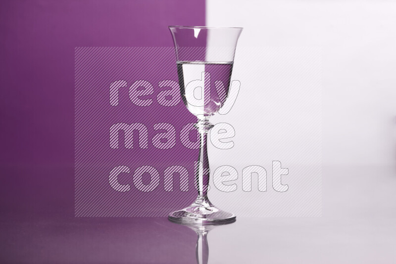 The image features a clear glassware filled with water, set against white and purple background