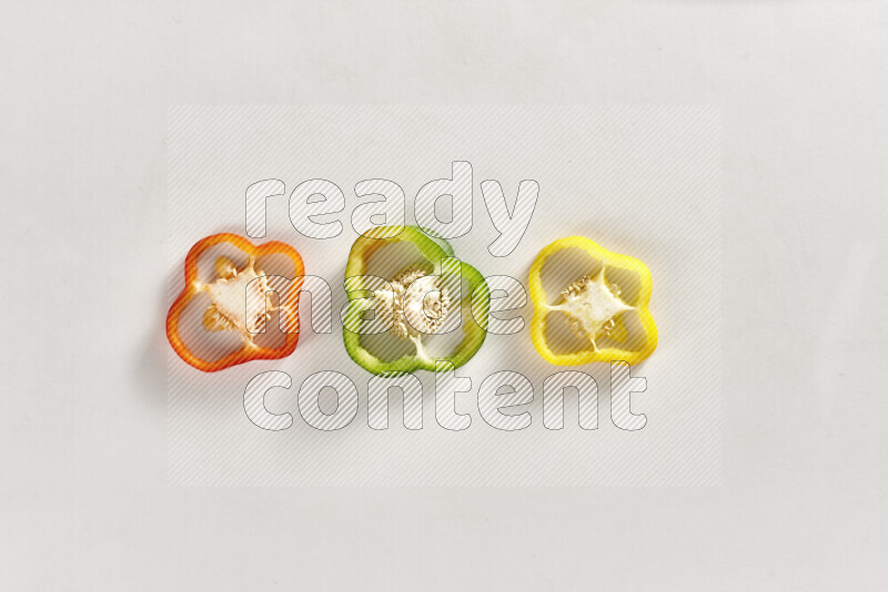 Assorted bell pepper slices on white background