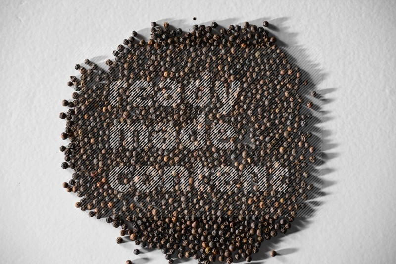 Black pepper on a white flooring