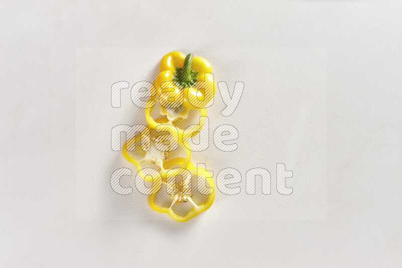 Yellow bell pepper slices on white background