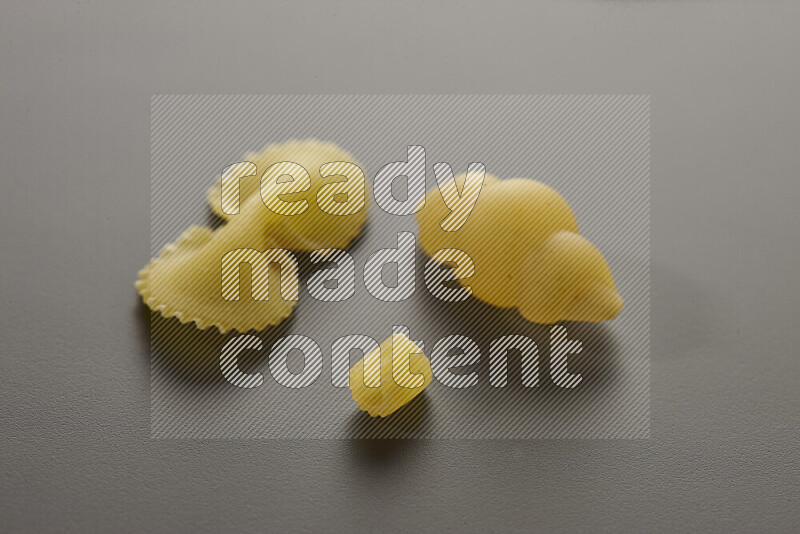 Different pasta types on grey background