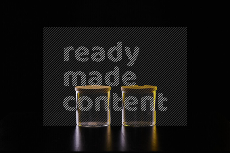 Glassware with rim light in yellow and white against black background