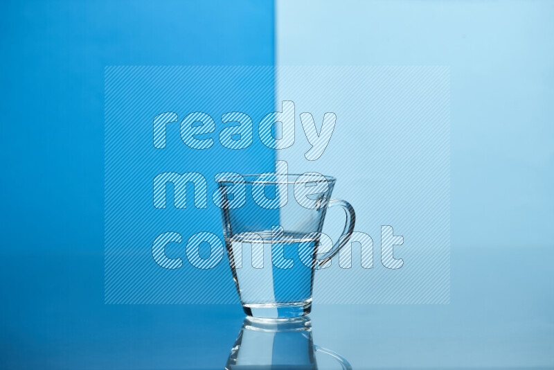 The image features a clear glassware filled with water, set against blue and light blue background