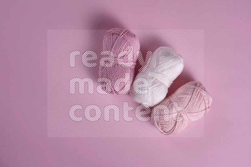 White sewing supplies on pink background