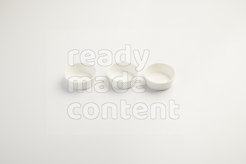 white ceramic round sauce dish on white countertop