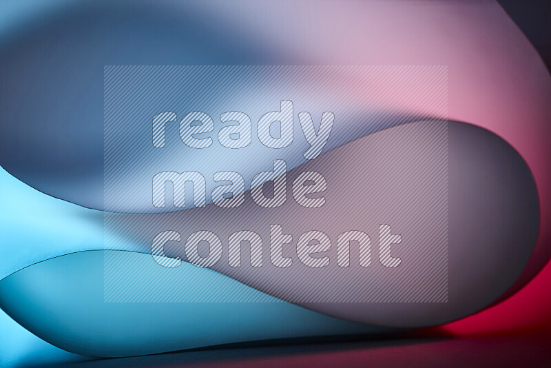 An abstract art piece displaying smooth curves in blue and red gradients created by colored light