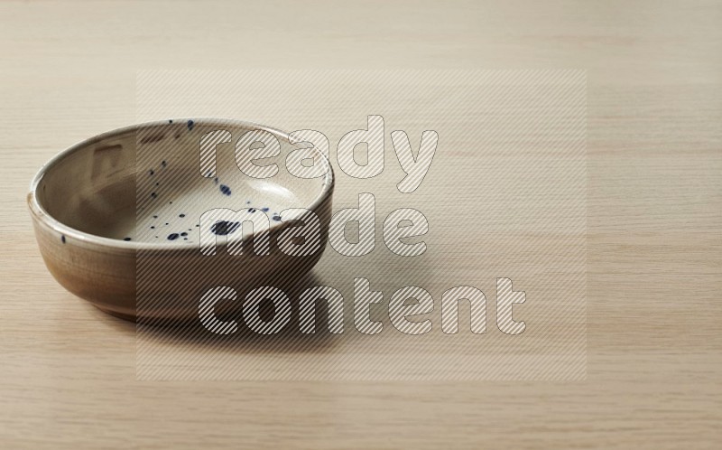 Multicolored Pottery Bowl on Oak Wooden Flooring, 15 degrees