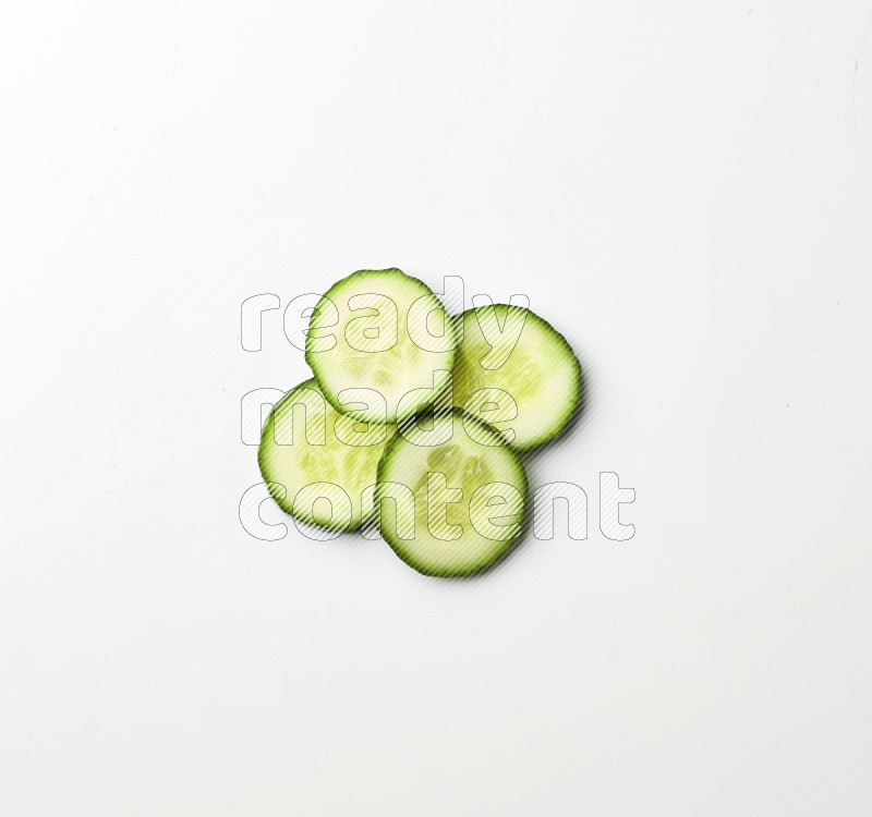 Multiple cucumber slices on white background