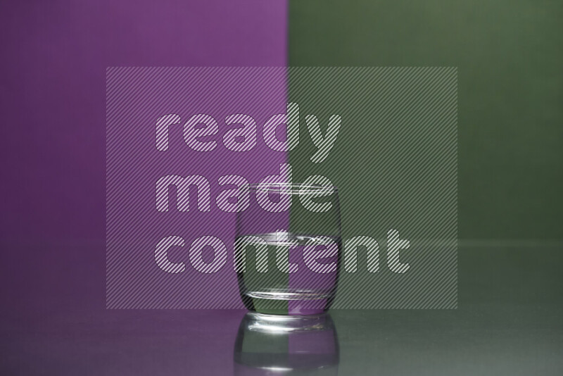 The image features a clear glassware filled with water, set against purple and dark green background