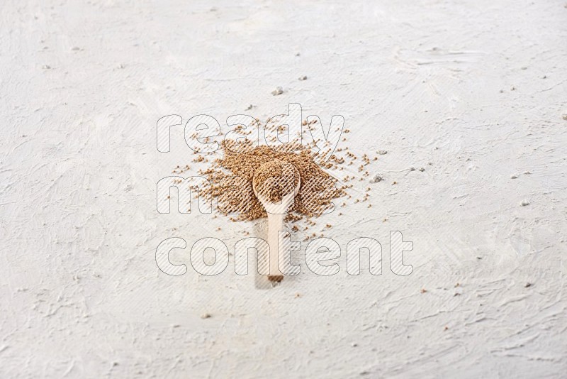 A wooden spoon full of mustard seeds on a textured white flooring in different angles