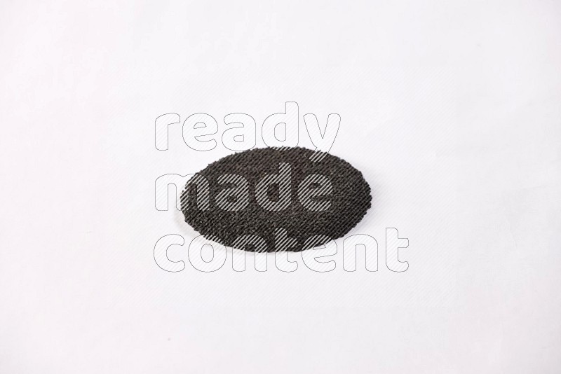 Black seeds in a circle shape on a white flooring in different angles