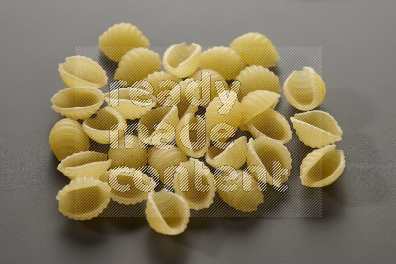 Shells pasta on grey background