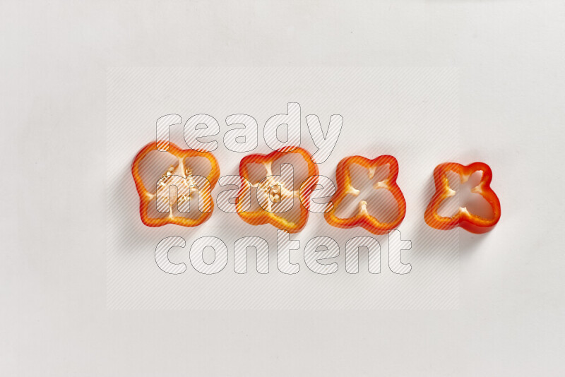 Red bell pepper slices on white background