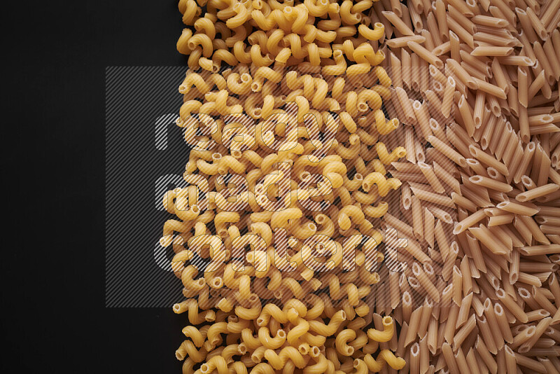 Different pasta types on black background