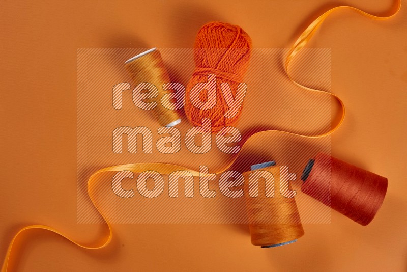 Orange sewing supplies on orange background