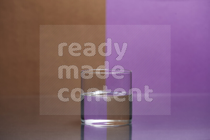 The image features a clear glassware filled with water, set against brown and purple background