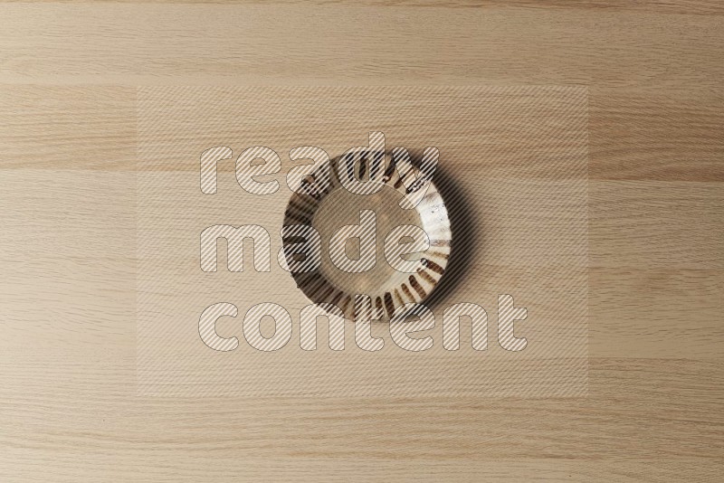 Top View Shot Of A Multicolored Pottery Plate on Oak Wooden Flooring